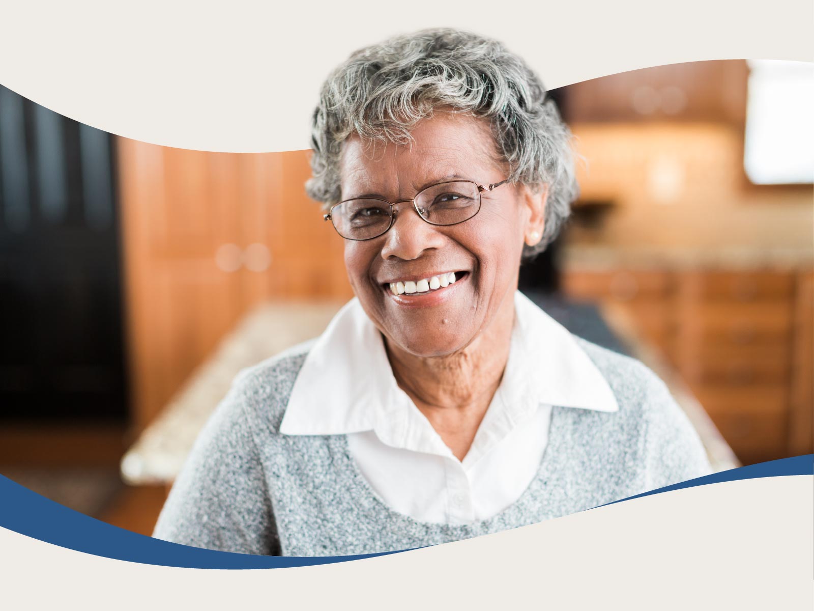 Neatly dressed elderly woman smiling at home